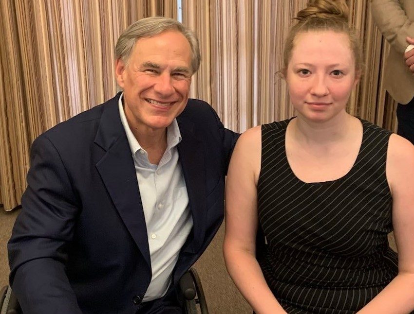 Photo of TXGR Legislative Director Bethany Young with Texas Governor Greg Abbott at the bill signing event.